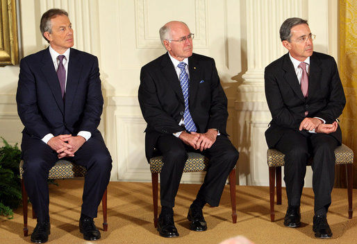 Former Prime Minister Tony Blair of the United Kingdom, is joined by Australia's former Prime Minister John Howard and Colombian President Alvaro Uribe as they sit onstage in the East Room of the White House Tuesday, Jan. 13, 2009, during a ceremony honoring them as 2009 recipients of the Presidential Medal of Freedom. Established by Executive Order in 1963, the medal is America's highest civil award. White House photo by Chris Greenberg