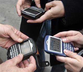 image showing 3 people using blackberry mobile devices