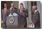 President George W. Bush welcomes UN Secretary General Kofi Annan to the podium after his announcement of Presidential HIV/AIDS Trust Fund Initiative as Nigerian President Olusegun Obsanjo looks on at left in the Rose Garden, Friday, May 11. WHITE HOUSE PHOTO BY ERIC DRAPER