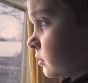 boy standing at a window