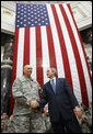 President George W. Bush stands on stage with U.S. Commander in Iraq, General Ray Odierno, Sunday, Dec. 14, 2008, following his address to U.S. military and diplomatic personnel at the Al Faw Palace-Camp Victory in Baghdad.  White House photo by Eric Draper