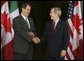 President George W. Bush greets Mexican President Vicente Fox at the beginning of meetings between the United States, Mexico and Canada at Baylor University in Waco, Texas, Wednesday, March 23, 2005.  White House photo by Krisanne Johnson