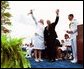 Following his commencement address to the U.S. Coast Guard Academy, Vice President Dick Cheney and Cadet Jen Frye, 22, of New Market, Va., wave to her friends and family after he presented the graduating cadet her commission in New London, Conn., Wednesday, May 19, 2004. White House photo by David Bohrer.