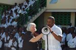 Congressman Kendrick Meek introduces U.S. Ambassador to Haiti Janet Sanderson who speaks to the students of the Becky DeWine school in Cité Soleil.