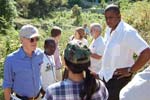 Sen. Jeff Bingaman and Congressman Kendrick B. Meek are briefed at a USAID Watershed Restoration Project in the hills above the Port-Au-Prince suburb of Pacot. 