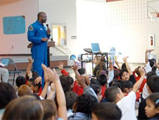 A NASA astronaut addresses school students.