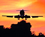 Photo: plane flying with sunset background. Click to read more about Aviation Program