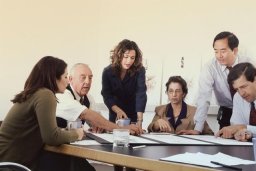 People have a meeting at a table.