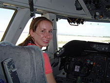 Lawson sits in an aircraft pilot's seat
