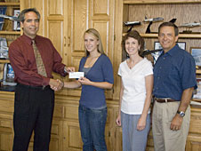 David McBride presents the 2008 Dryden Employee Exchange Council scholarship check to Jill Pestana, as her parents look on.