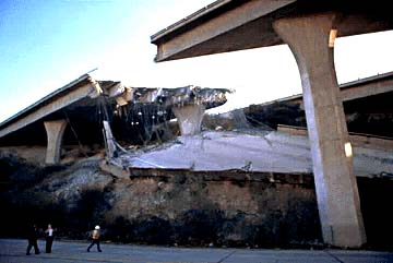 Photo of a freeway broken apart as a result of an earthquake.