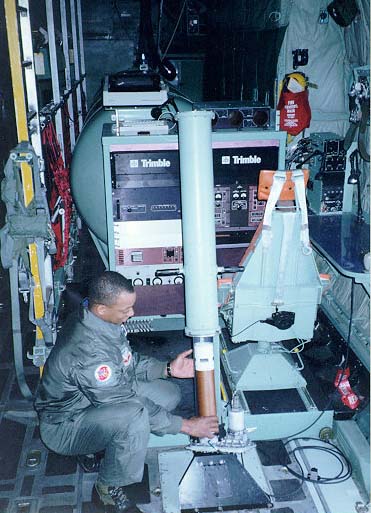 The dropsonde system operator prepares to drop the parachute-borne sensor.