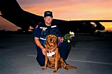 Photo of a firefighter and a dog.