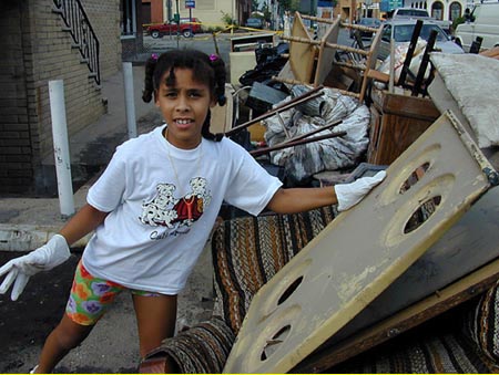 Photo of a child sifting through debris.