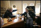 President George W. Bush and Japan's Prime Minister Junichiro Koizumi talk together on Air Force One Friday, June 30, 2006, as they fly to visit Graceland in Memphis. White House photo by Eric Draper