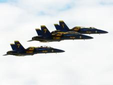 Three of the U.S. Navy's Blue Angels F/A-18 jets in flight.