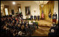President George W. Bush speaks on stage in the East Room of the White House Tuesday, Jan. 13, 2009, during the Ceremony for the 2009 Recipients of the Presidential Medal of Freedom. With him on stage are the recipients, from left: Former Prime Minister Tony Blair of the United Kingdom, former Prime Minister John Howard of Australia, and President Alvaro Uribe of Colombia. White House photo by Chris Greenberg