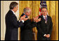 Colombian President Alvaro Uribe is congratulated by former Prime Minister John Howard of Australia, and former Prime Minister Tony Blair, left, of the United Kingdom after he was honored by President George W. Bush with the 2009 Presidential Medal of Freedom during ceremonies honoring all three leaders with America's highest civil award. White House photo by Joyce N. Boghosian