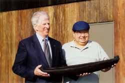 Picture of Rep. Thompson and Larry Hendrix, Yurok Tribal Councilmember and UIHS Board Member -- presentation to Congressman Thompson of a replica of the dug-out canoe used at the ceremonial signing of the Trinity River Record of Decisions, December 2000. The canoe was sculpted by artist, George Blake and is on display in the Congressman's Washington, DC office. 