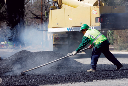 man laying cooler asphalt