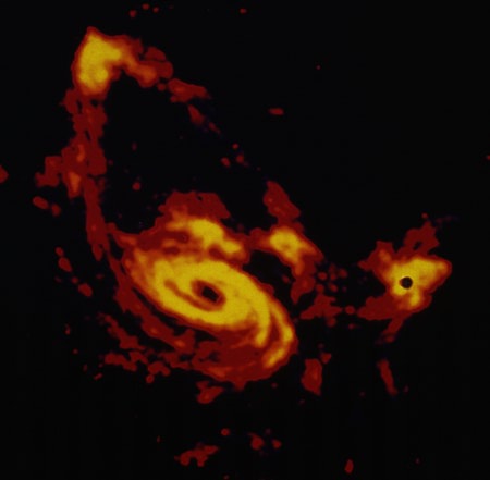 Radio telescope image of M81 (lower left), M82 (right), and NGC3077 (upper left); the emissions come mainly from neutral Hydrogen