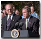 Accompanied by firemen and other distinguished guests, President George W. Bush speaks during a ceremony held to honor the gift of a new firetruck for the city of New York on the South Lawn Dec. 19. Donated by the state of Louisiana, the "Spirit of Louisiana," will replace one of the 35 firetrucks that were destroyed in the Sept. 11 attacks. Standing with the President is Ronald Goldman (left), Louisiana Governor Mike Foster (center), and Louisiana Representative Hunt Downer. White House photo by Tina Hager.