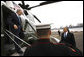 President George W. Bush is welcomed by United Nations U.S. Ambasador Dr. Zalmay Khalilzad as he arrives Monday, Sept. 22, 2008, aboard Marine One at the Wall Street helicopter landing area in New York City. President Bush will address the United Nations General Assembly on Tuesday. White House photo by Eric Draper