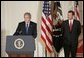 With Chief Justice John Roberts looking on, President George W. Bush makes remarks Thursday, Sept. 29, 2005, after the swearing-in ceremony in the East Room of the White House. Justice Roberts was confirmed earlier in the day by a 78-22 Senate vote. White House photo by Paul Morse