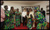 Mrs. Laura Bush and Madame Chantal de Souza Yayi, wife of President Boni Yayi of Benin, watch as representatives of the USAID-Supported Mothers' Association perform Saturday, Feb. 16, 2008, during their visit in Cotonou, Benin.