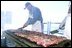 The Pacific Ocean (Apr. 28, 2003) -- Volunteers from Harris Ranch Steakhouse barbecue steaks on the fantail for the crew to show their support for the USS Abraham Lincoln’s (CVN 72) participation in Operation Iraqi Freedom. The volunteers used their own money to buy the steaks for over 5000 crewmembers aboard Lincoln. U.S. Navy photo by Airman Geanine I. Ortez