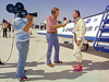 A TV reporter interviews NASA test pilot Bill Dana, wearing his infamous pink boots with yellow daisy decals, after the last powered flight of the X-24B.