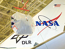 SOFIAs primary mirror assembly is lifted above wing level prior to its reinstallation in the telescope cavity of NASAs 747 airborne observatory Oct. 8, 2008.