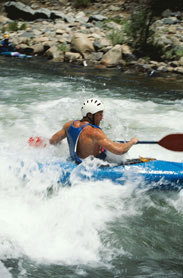 This photograph shows examples of mechanical energy, which include the river’s flow and the movement of the boater’s paddle. The boater’s body is converting the chemical energy from food into the mechanical energy needed to guide the kayak.