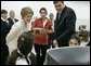 Laura Bush and Queen Raina Al-Abdullah, wife of King Abdullah of Jordan, center, talk with students during a computer lab at the Discovery School of Swaifiyeh Secondary School in Amman, Jordan, Sunday, May 22, 2005. White House photo by Krisanne Johnson