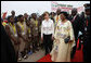 Mrs. Laura Bush and Madame Chantal de Souza Yayi, First Lady of Benin, walk the red carpet upon the arrival Saturday, Feb. 16, 2008, of Mrs. Bush and President George W. Bush to Benin. White House photo by Eric Draper