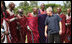 President George W. Bush joins members of a Maasai warrior dance group during their performance to welcome President Bush and Mrs. Laura Bush Monday, Feb. 18, 2008, to the Maasai Girls School in Arusha, Tanzania.