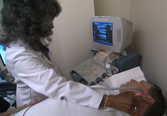 technician tests patient with carotid artery ultrasound