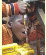 kid at water faucet