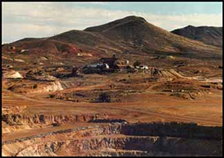 Ground photo showing altered volcanic rocks at Goldfield, with prominent brown iron staining.