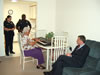 Congressman Rob Andrews visits with a resident of the Chesilhurst House to discuss the federal funding received by residents to have air conditioning units installed in their facility.