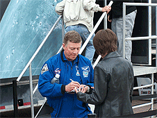 Watertown, SD – Astronaut Mike Fossum signs autographs while he waits to go into the Exploration experience.