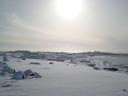 The sun shines on the bright white snow covered St. Paul Village, viewed from a distance