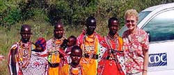 Global AIDS Program staff member standing next to local residents