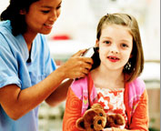 doctor examining little girl