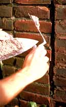 Home page logo: Soft mortar being used for repointing. Photo: John P. Speweik.