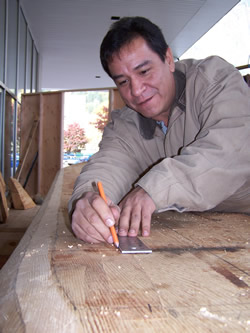 Douglas Chilton carving canoe