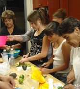 Family members of all ages work together to prepare vegetables and fruit for dinner during a Diabetes and the Family class.