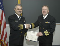 Captain Frank Hearl (left) receives his Meritorious Service Medal from Captain Greg Kullman, NIOSH