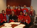 Cincinnati employees shown wearing red are: front row (l-r) Joy Shattuck, Jeannie Nigam, Relada Miller, Thais Morata; back row (l-r) Christine Toennis, Kathleen Mitchell, Glenda Wong, Randall Smith, Mary Ann Butler.