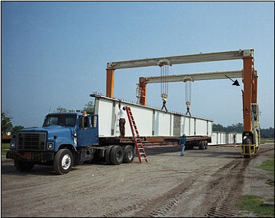 Photo 1: Manufacturer’s photo of mobile gantry crane. Note arrow pointing to operators cab